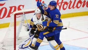 Boston Bruins centre Fraser Minten (93) and Buffalo Sabres center Tage Thompson (72) battle for position during the third period of an NHL hockey game. (Jeffrey T. Barnes/AP)
