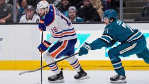 Edmonton Oilers center Jason Dickinson (16) moves the puck while defended by San Jose Sharks center Macklin Celebrini (71) during the first period of an NHL hockey game, Wednesday, April 8, 2026, in San Jose, Calif. (Godofredo A. Vásquez/AP)