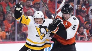Pittsburgh Penguins' Bryan Rust, left, and Philadelphia Flyers' Travis Sanheim collide during the first period of Game 3 in the first round of the NHL Stanley Cup Playoffs Wednesday, April 22, 2026, in Philadelphia. (Matt Slocum/AP Photo)