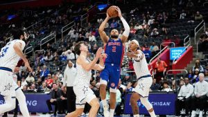 Detroit Pistons guard Cade Cunningham (2) shoots against, from left, Orlando Magic center Goga Bitadze, and forwards Franz Wagner, and Paolo Banchero during the second half of an NBA basketball game. (Ryan Sun/AP)