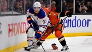 Edmonton Oilers centre Ryan Nugent-Hopkins skates the puck away from Anaheim Ducks defenseman Radko Gudas (7) during an NHL hockey game Monday, April 7, 2025, in Anaheim, Calif. (Jayne Kamin-Oncea/AP)