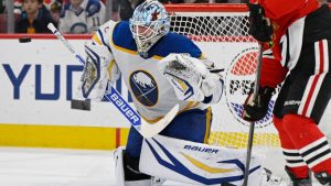 Buffalo Sabres goalie Ukko-Pekka Luukkonen, left, makes a save during the second period of an NHL hockey game against the Chicago Blackhawks in Chicago, Monday, April 13, 2026. (Paul Beaty/AP Photo)