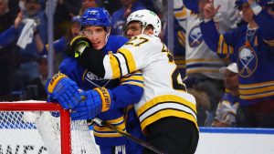 Boston Bruins defenceman Hampus Lindholm (27) grabs Buffalo Sabres centre Tage Thompson (72) during the first period in Game 1 of a first-round NHL hockey Stanley Cup playoff series Sunday, April 19, 2026, in Buffalo, N.Y. (Jeffrey T. Barnes/AP Photo)