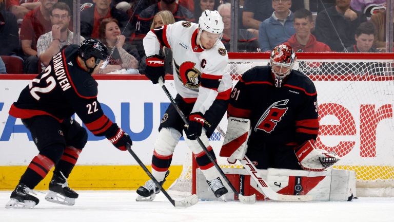 Carolina Hurricanes goaltender Frederik Andersen (31) blocks a shot by Ottawa Senators' Brady Tkachuk (7) with Hurricanes' Logan Stankoven (22) nearby during the second period of an Game 1 of an NHL hockey Stanley Cup first-round playoff series in Raleigh, N.C., Saturday, April 18, 2026. (Karl DeBlaker/AP)