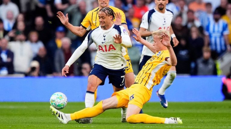 Tottenham Hotspur's Xavi Simons, left, and Brighton and Hove Albion's Jan Paul van Hecke battle for the ball during their English Premier League soccer match in London, Saturday, April 18, 2026. (Jordan Pettitt/PA via AP)