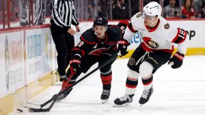 Carolina Hurricanes' Sebastian Aho (20) battles with Ottawa Senators' Tim Stützle (18) for the puck during the second period of Game 2 of an NHL hockey Stanley Cup first-round playoff series. (Karl DeBlaker/AP)