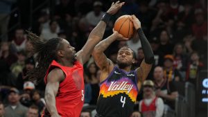 Phoenix Suns guard Jalen Green (4) shoots over Portland Trail Blazers guard Jrue Holiday during the second half of an NBA basketball game, Sunday, Feb. 22, 2026, in Phoenix. (Rick Scuteri/AP Photo)