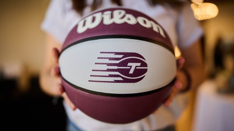 A Toronto Tempo logo on a basketball is shown as members of the media watch a broadcast of the WNBA Expansion Draft in Toronto, on Friday, April 3, 2026. (Sammy Kogan/CP)