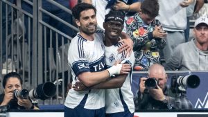 Vancouver Whitecaps' Brian White (left) celebrates his goal against the Colorado Rapids with Emmanuel Sabbi (11) during the first half of an MLS soccer match in Vancouver, on Saturday, April 25, 2026. (Ethan Cairns/THE CANADIAN PRESS)