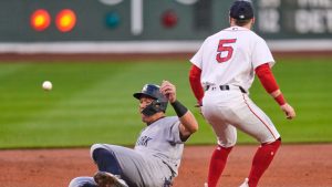 New York Yankees' Aaron Judge, left, beats the throw to Boston Red Sox third baseman Caleb Durbin (5) while advancing on a double by Giancarlo Stanton during the first inning during of a baseball game at Fenway Park, Wednesday, April 22, 2026, in Boston. (Charles Krupa/AP)