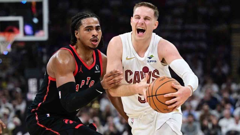 Cleveland Cavaliers guard Sam Merrill drives on Toronto Raptors forward Collin Murray-Boyles during the second half in Game 5 of a first-round NBA playoffs basketball series, Wednesday, April 29, 2026, In Cleveland. (AP Photo/David Dermer)