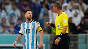 Referee Daniele Orsato talks to Argentina's Lionel Messi, left, during the World Cup semifinal soccer match between Argentina and Croatia at the Lusail Stadium in Lusail, Qatar, Dec. 13, 2022. (Petr David Josek/AP)