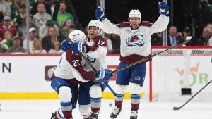 Colorado Avalanche center Parker Kelly, center, celebrates after scoring during the third period of Game 4 in an NHL Stanley Cup hockey second-round playoff series against the Minnesota Wild, Monday, May 11, 2026, in St. Paul, Minn. (Abbie Parr/AP)