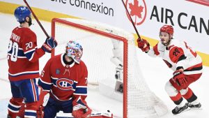 Carolina Hurricanes' Sebastian Aho (20) reacts after scoring on Montreal Canadiens goaltender Jakub Dobes (75) as teammate Juraj Slafkovsky (20) looks on during overtime period of Game 3 of the NHL Eastern Conference final Stanley Cup playoff series in Montreal on Monday, May 25, 2026. (Graham Hughes/AP)