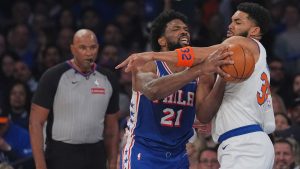 New York Knicks' Karl-Anthony Towns, right, fouls Philadelphia 76ers' Joel Embiid during the first half of Game 1 in a second-round NBA basketball playoffs series Monday, May 4, 2026, in New York. (AP Photo/Seth Wenig)