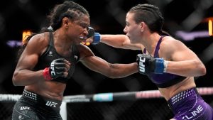 Fatima Kline, right, punches Angela Hill, left, during the third round of a women's strawweight bout in the UFC. (Yuki Iwamura/AP)