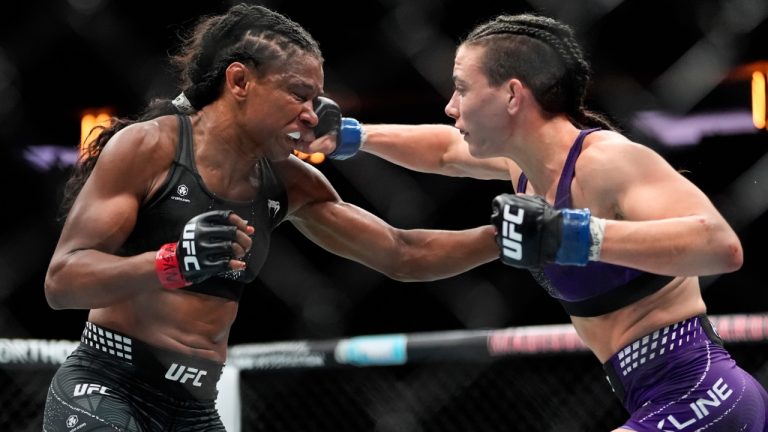 Fatima Kline, right, punches Angela Hill, left, during the third round of a women's strawweight bout in the UFC. (Yuki Iwamura/AP)