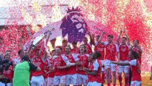 Arsenal players celebrate their Premier League title with the trophy after the English Premier League soccer match between Crystal Palace and Arsenal in London, England, Sunday, May 24, 2026. (Kin Cheung/AP)