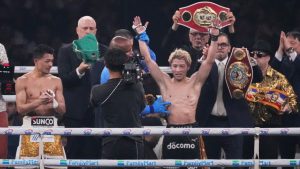 Naoya Inoue of Japan, right, raises his arms as he beat Junto Nakatani of Japan in a boxing match for the WBA, WBC, IBF and WBO super bantamweight world title in Tokyo, Saturday, May 2, 2026. (Hiro Komae/AP)