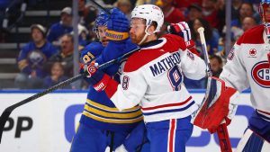 Buffalo Sabres right wing Josh Doan, left, and Montreal Canadiens defenseman Mike Matheson (8) battle for position during the first period in Game 1 of a second-round NHL hockey Stanley Cup playoff series, Wednesday, May 6, 2026, in Buffalo, N.Y. (Jeffrey T. Barnes/AP)