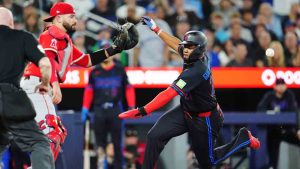 Toronto Blue Jays' Vladimir Guerrero Jr. (right) scores ahead of the tag from Los Angeles Angels catcher Sebastian Rivero (38) during third inning MLB baseball action in Toronto on Friday, May 8, 2026. (Frank Gunn/CP)