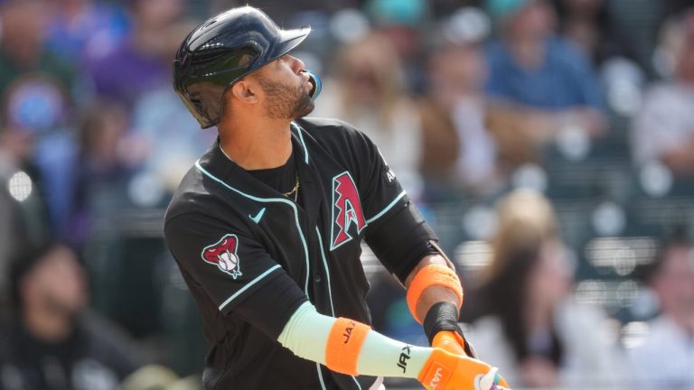 Arizona Diamondbacks' Lourdes Gurriel Jr. follows the flight of his solo home run off Colorado Rockies starting pitcher Michael Lorenzen in the fifth inning of a baseball game, Sunday, May 17, 2026, in Denver. (AP Photo/David Zalubowski)