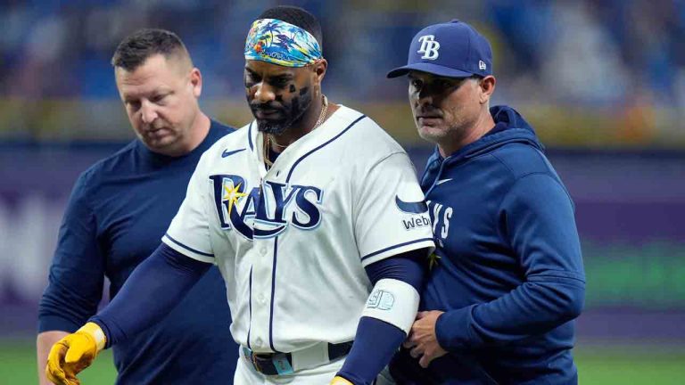 Tampa Bay Rays' Yandy DÃaz, cengter, is helped off the field by a trainer and manager Kevin Cash, right, after getting hit with a pitch by Baltimore Orioles pitcher Yennier Cano during the eighth inning of a baseball game Tuesday, May 19, 2026, in St. Petersburg, Fla. (Chris O'Meara/AP)