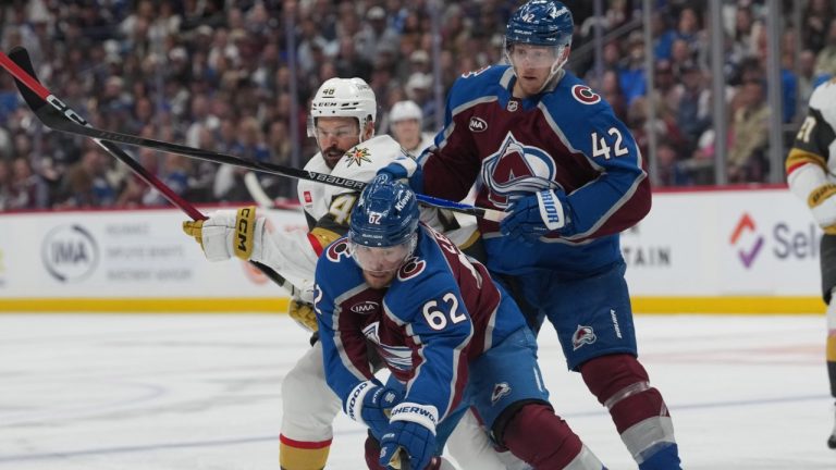 Colorado Avalanche left wing Artturi Lehkonen, front, collects the puck as defenseman Josh Manson, back right, checks Vegas Golden Knights center Tomas Hertl during the second period in Game 2 of the Western Conference finals NHL hockey Stanley Cup playoff series Friday, May 22, 2026, in Denver. (AP Photo/David Zalubowski)