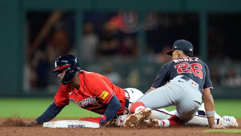 Atlanta Braves' Jorge Mateo (2) steals second base against Washington Nationals second baseman Nasim Nuñez (26) in the nineth inning of a baseball game, Friday, May 22, 2026, in Atlanta. (AP Photo/Mike Stewart)