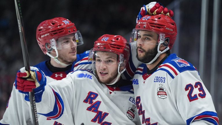 Kitchener Rangers' Dylan Edwards, centre, Sam O'Reilly, right, and Cameron Reid celebrate O'Reilly's goal during the third period of a Memorial Cup hockey game against the Kelowna Rockets, in Kelowna, B.C., on Friday, May 22, 2026. THE CANADIAN PRESS/Darryl Dyck