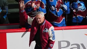 Claude Lemieux waves as he is introduced during a ceremony to honor members from the 1996 Stanley Cup Championship team of the Colorado Avalanche before an NHL hockey game against the Florida Panthers Thursday, Dec. 11, 2025, in Denver. (AP Photo/David Zalubowski)