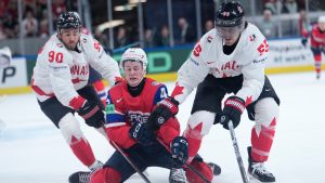 Norway's Johannes Johannesen (4), centre, challenges for the puck with Canada's Ryan O'Reilly (90), left, and Canada's Mark Scheifele (55) during the 2026 IIHF Men's Ice Hockey World Championship bronze medal match between Canada and Norway, in Zurich, Switzerland, Sunday, May 31, 2026. (Darko Bandic/AP)
