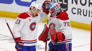 Montreal Canadiens defenceman Kaiden Guhle (21) and goaltender Jakub Dobes (75) celebrate victory during the third period in Game 2 of a second-round NHL hockey Stanley Cup playoff series against the Buffalo Sabres, Friday, May 8, 2026, in Buffalo, N.Y. (Jeffrey T. Barnes/AP)