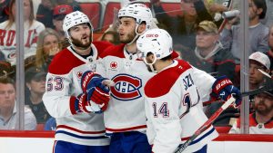 Montréal Canadiens' Juraj Slafkovský (20), centre, celebrates his goal with Nick Suzuki (14) and Noah Dobson (53) during the third period in Game 1 of the Eastern Conference finals NHL hockey Stanley Cup playoffs series against the Carolina Hurricanes in Raleigh, N.C., Thursday, May 21, 2026. (Karl DeBlaker/AP)