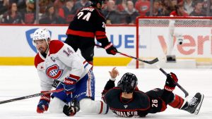 Montréal Canadiens' Nick Suzuki (14) collides with Carolina Hurricanes' Seth Jarvis (24) resulting in both getting penalties during the first period in Game 1 of the Eastern Conference finals NHL hockey Stanley Cup playoffs series in Raleigh, N.C., Thursday, May 21, 2026. (Karl DeBlaker/AP)