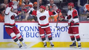 Carolina Hurricanes' Logan Stankoven (22) celebrate after scoring a goal with Taylor Hall (71) and Sean Walker (26) during the third period of Game 4 in a second-round NHL hockey Stanley Cup playoff series against the Philadelphia Flyers Saturday, May 9, 2026, in Philadelphia. (Matt Slocum/AP)