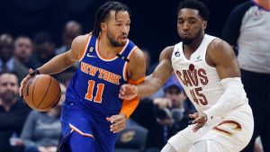 New York Knicks guard Jalen Brunson (11) drives against Cleveland Cavaliers guard Donovan Mitchell (45) during the first half of an NBA basketball game Friday, March 31, 2023, in Cleveland. (AP Photo/Ron Schwane)