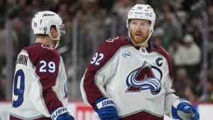 Colorado Avalanche center Nathan MacKinnon (29) and left wing Gabriel Landeskog (92) wait for play to resume during the third period of Game 4 in an NHL Stanley Cup hockey second-round playoff series against the Minnesota Wild Monday, May 11, 2026, in St. Paul, Minn. (Abbie Parr/AP)