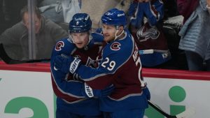 Colorado Avalanche defenseman Cale Makar, left, congratulates center Nathan MacKinnon after he scored a goal against the Minnesota Wild in the third period of Game 1 of an NHL hockey Stanley Cup second-round playoff series Sunday, May 3, 2026, in Denver. (David Zalubowski/AP)