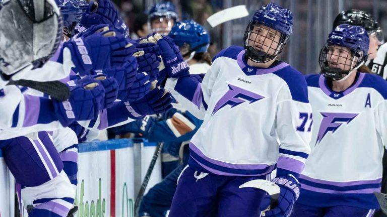 Minnesota Frost's Britta Curl-Salemme (77) celebrates her empty net goal against the Vancouver Goldeneyes with her teammates during third period PWHL hockey action. (Ethan Cairns/THE CANADIAN PRESS)