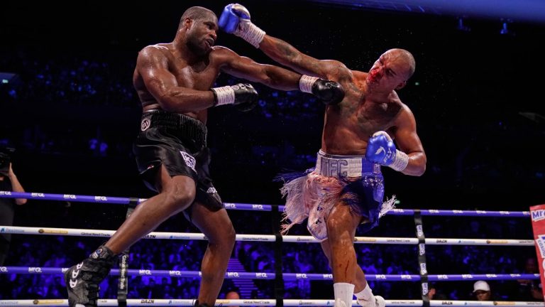 Britain's Fabio Wardley, right, swings and tries to connect with Britain's Daniel Dubois during their WBO World Heavyweight boxing title bout in Manchester, Saturday, May 9, 2026. (AP Photo/Dave Thompson)