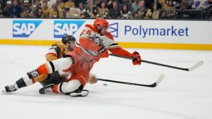 Anaheim Ducks centre Jansen Harkins (24) attempts to shoot past Vegas Golden Knights defenseman Ben Hutton (17) during the first period of Game 2 of a second-round NHL hockey Stanley Cup playoff series Wednesday, May 6, 2026, in Las Vegas. (John Locher/AP)