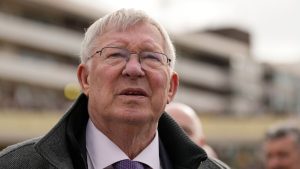 Former Manchester United manager Alex Ferguson, watches a large TV screen during The County Hurdle race, during the final day of the Cheltenham Festival at Cheltenham Racecourse, England, Friday, March 15, 2024. (Dave Shopland/AP)