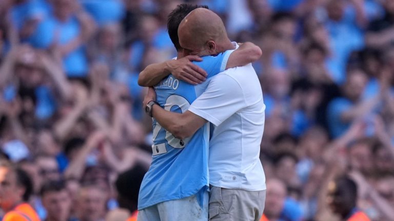 Manchester City's head coach Pep Guardiola hugs Manchester City's Bernardo Silva as he played last match for the team during a Premier League soccer match between Manchester City and Aston Villa in Manchester, England, Sunday, May 24, 2026. (AP Photo/Alastair Grant)