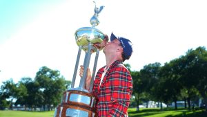 Russell Henley kisses the winner's trophy after the final round of the Charles Schwab Challenge golf tournament at Colonial Country Club in Fort Worth, Texas, Sunday, May 31, 2026. (LM Otero/AP)