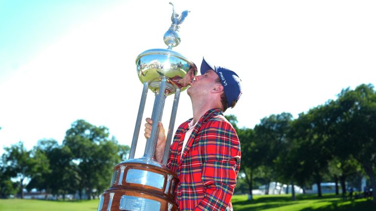 Russell Henley kisses the winner's trophy after the final round of the Charles Schwab Challenge golf tournament at Colonial Country Club in Fort Worth, Texas, Sunday, May 31, 2026. (LM Otero/AP)