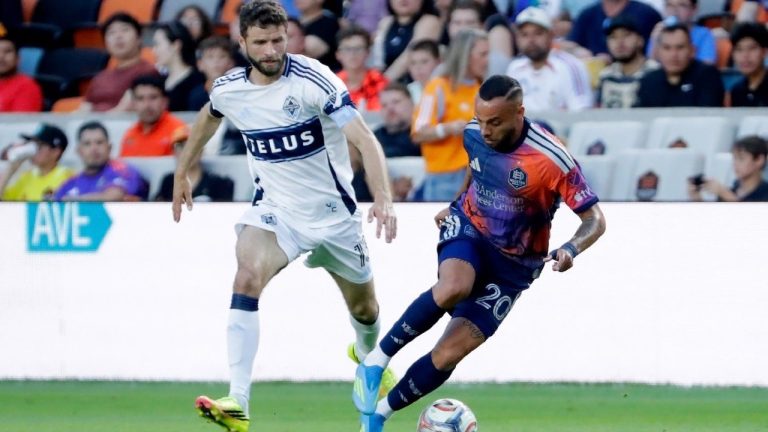 Houston Dynamo FC midfielder Guilherme Santos, right, moves the ball past Vancouver Whitecaps FC midfielder Thomas Muller during the first half of an MLS match, Saturday, May 16, 2026, in Houston. (AP/Michael Wyke)
