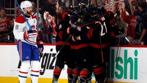 Carolina Hurricanes players celebrate after a goal by Eric Robinson as Montreal Canadiens' Mike Matheson (8) skates by during the first period in Game 5 of the Eastern Conference finals NHL hockey Stanley Cup playoff series in Raleigh, N.C., Friday, May 29, 2026. (Karl DeBlaker/AP)