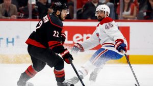 Carolina Hurricanes' Logan Stankoven (22) controls the puck with Montreal Canadiens' Alexandre Carrier (45) nearby during the first period in Game 5 of the Eastern Conference finals NHL hockey Stanley Cup playoff series in Raleigh, N.C., Friday, May 29, 2026. (Karl DeBlaker/AP)
