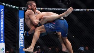 Jim Miller locks in a guillotine choke during a UFC lightweight fight. (Adam Hunger/AP)
